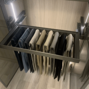 Spacious corner closet system with full-length hanging space and matte glass doors by Blue Valley Cabinets.