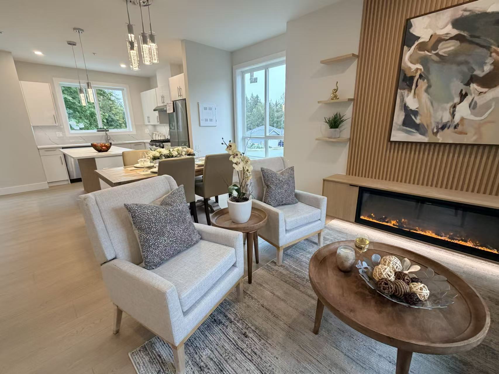 Coordinated custom millwork connecting a modern kitchen, dining area and fireplace feature wall